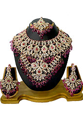 Breathtaking necklace set designed in a very unique approach. This beautiful Dark pink wedding and bridal purpose necklace awesomely crafted with white and pink diamonds studded drop frame with hanging crystal moti. A pair of matching earrings and beautiful maangtika embraces with this necklace. Keep away from water, sweat and perfume. Slight Color variations are possible due to differing screen and photograph resolution.