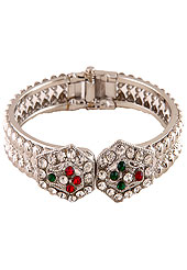 Classic, Elegant and timeless diamond bangle. This hexagonal patterned bangle is studded with white, red and green diamonds. This diamond base bangle is adjustable. Slight Color variations are possible due to differing screen and photograph resolution.