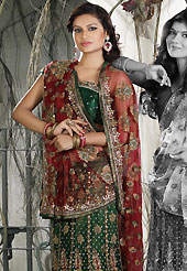 Outfit is a novel ways of getting yourself noticed. This maroon and green net lehenga style saree is nicely designed with embroidered and patch work in fabulous style. Embroidery is done with resham, zari, sequins, stone, cutdana, beads, kasab and cut moti work in form of floral motifs. Beautiful embroidery work on saree make attractive to impress all. This saree gives you a modern and different look in fabulous style. Matching blouse is available with this saree. Slight color variations are possible due to differing screen and photograph resolution.