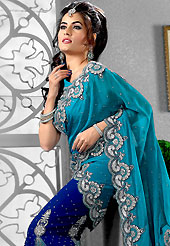 The traditional patterns used on this saree maintain the ethnic look. This turquoise blue and royal blue faux georgette lehenga style saree have beautiful embroidery patch work which is embellished with zari, sequins, stone, cutdana and cut motti work. Fabulous designed embroidery gives you an ethnic look and increasing your beauty. Matching blouse is available. Slight Color variations are possible due to differing screen and photograph resolutions.