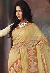 Take the fashion industry by storm in this beautiful printed saree. This beautiful yellow, rust and green cotton saree is nicely designed with stripe, abstract print and self weaving zari work. Beautiful print work on saree make attractive to impress all. It will enhance your personality and gives you a singular look. Matching blouse is available with this saree. Slight color variations are due to differing screen and photography resolution.